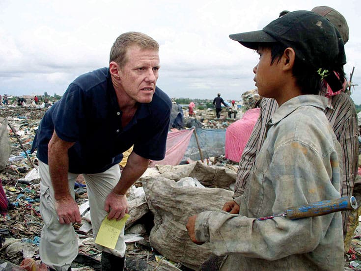 When Neeson visited the Stung Meanchey dump in Phnom Penh, he was horri ed to see 1500 children scavenging for food and survival. It was so hot he got burns on his feet from molten garbage. Photo Courtesy of Cambodian Children's Fund.