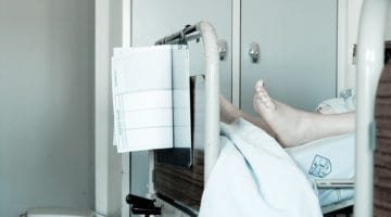 Feet at the end of a hospital bed,
