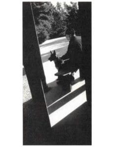 Father Marc with Kirka, a german shepherd.