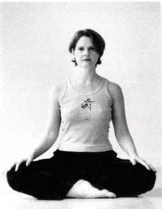 Cyndi Lee sitting in Sukhasana yoga pose