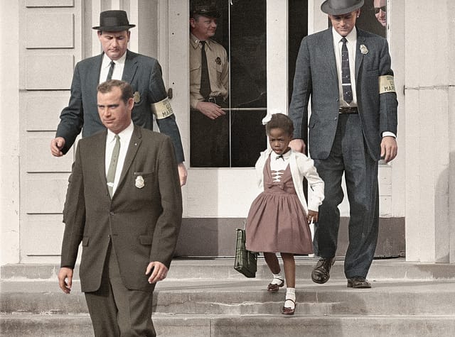 Ruby Bridges, the first African-American child to attend an all-white elementary school in the American South, escorted by U.S. Marshals dispatched by President Eisenhower for her safety. 14 November, 1960. Photo via flickr.