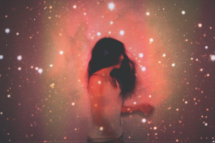 Woman with long hair surrounded by galaxy