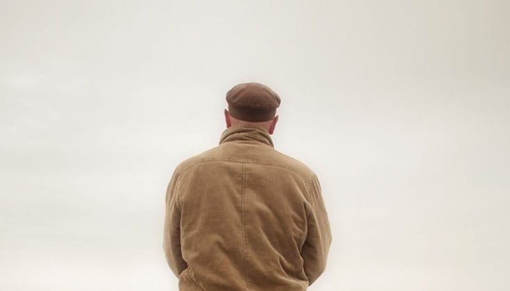 Bored man staring at wall.