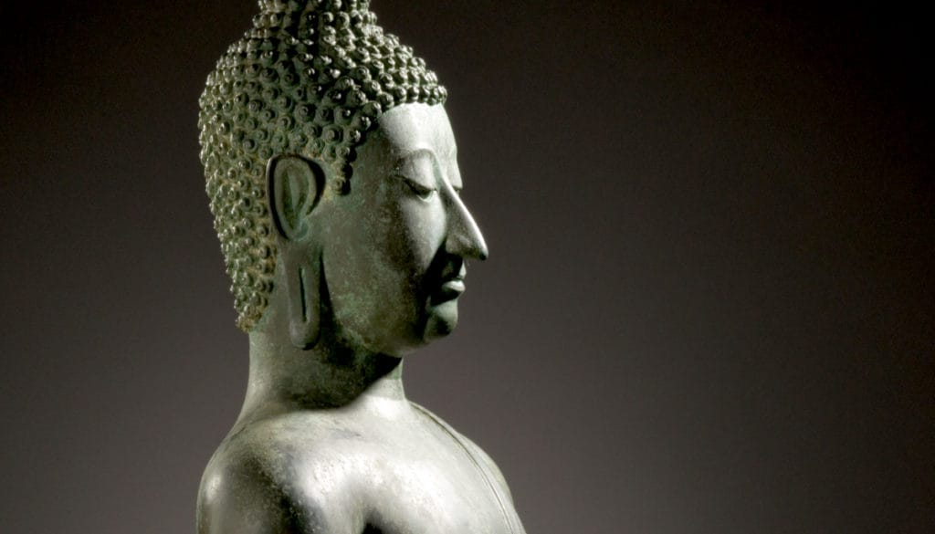 Head and shoulder of a statue of the Buddha in meditation.