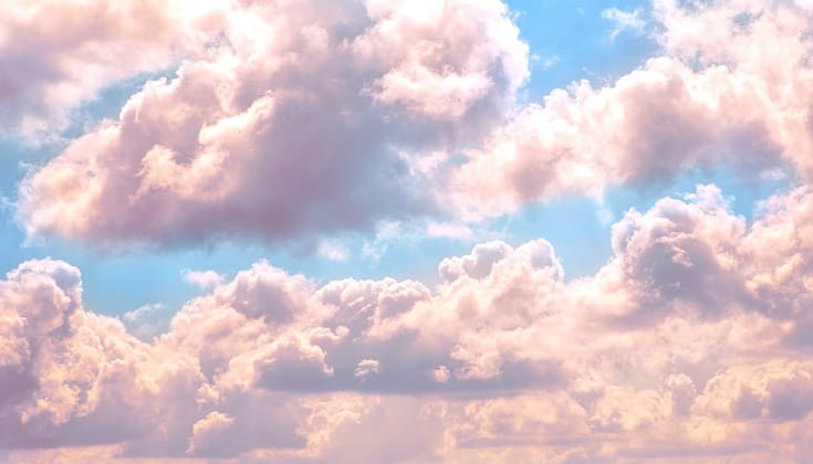 A bright blue sky with pink clouds.