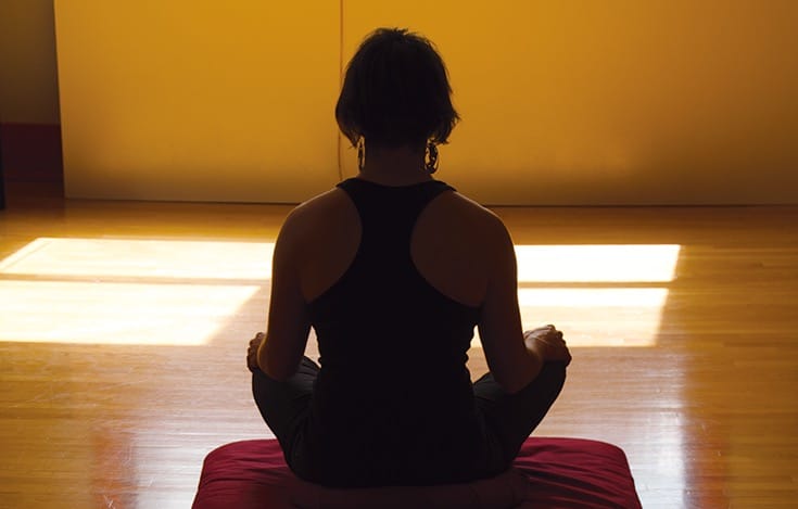 Woman sitting in meditation.