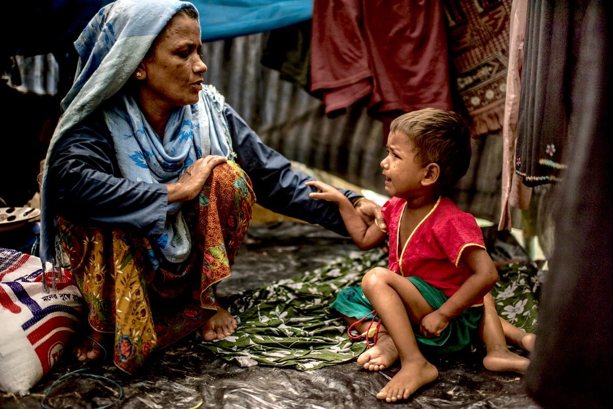 A woman and child in a refugee camp.