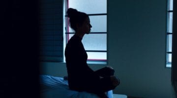 Sad woman sitting in meditation