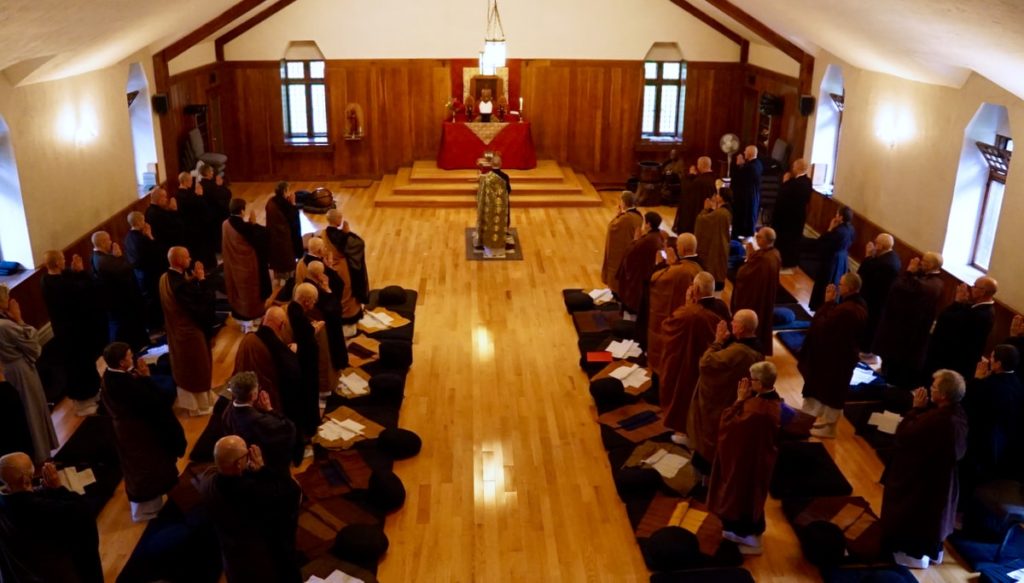 Dozens of priests gathered in a shrine hall.