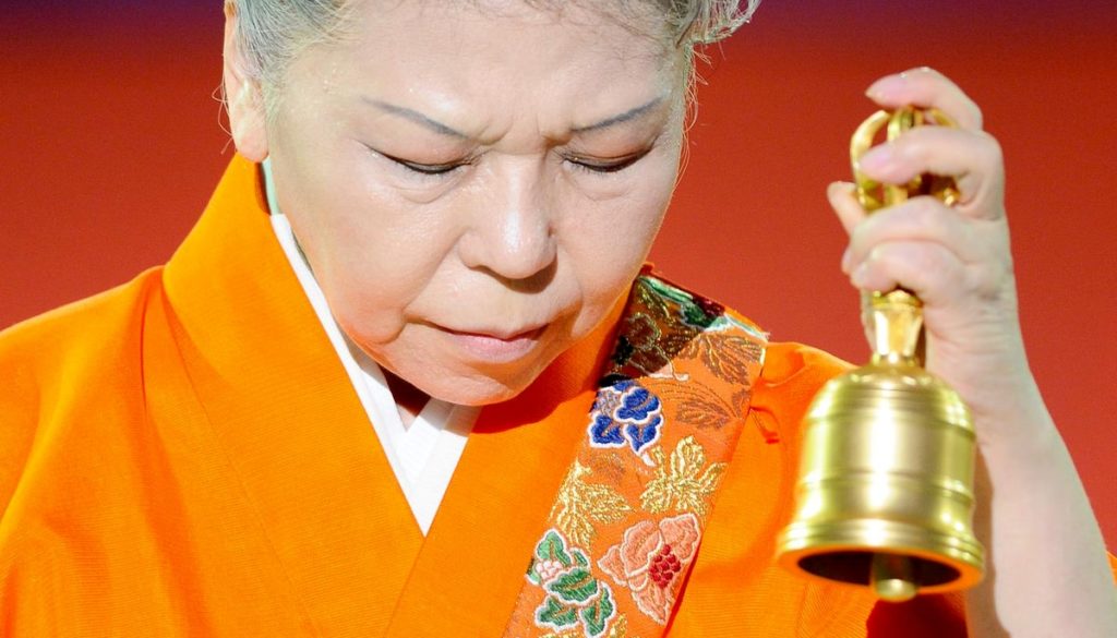 Shinso Ito holding a bell.