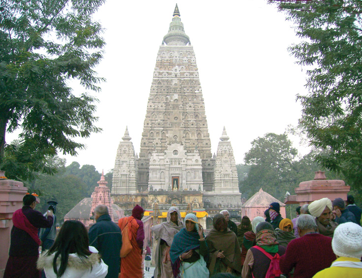 A crowd of people outside of a temple.