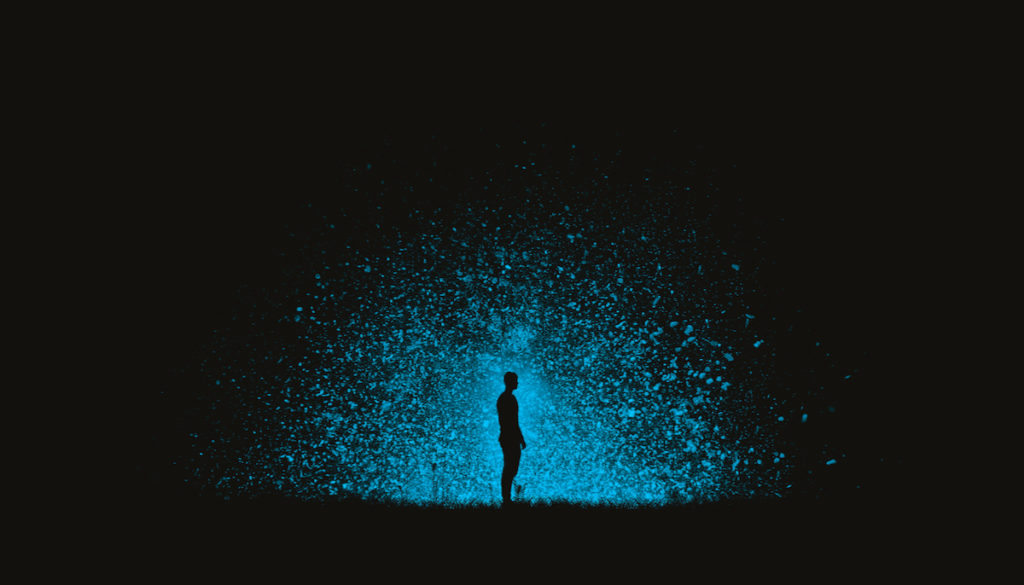 Man standing in explosion of light