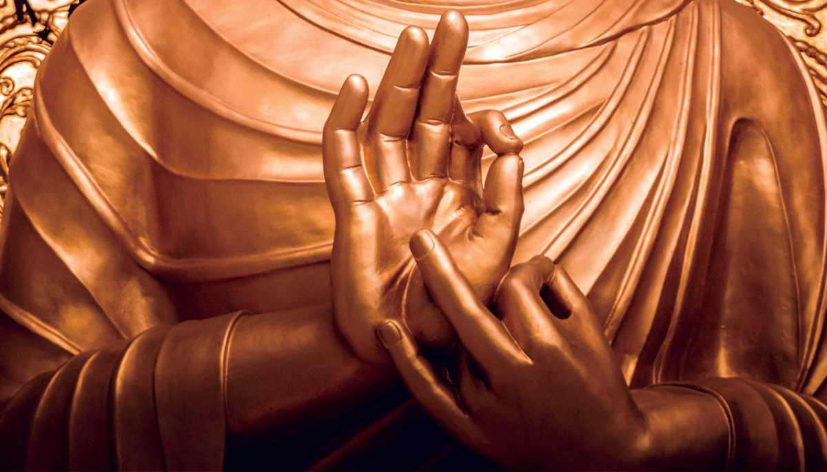 brass statue with hands.