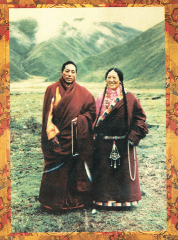 A man and a woman, both in robes, in front of a mountain.