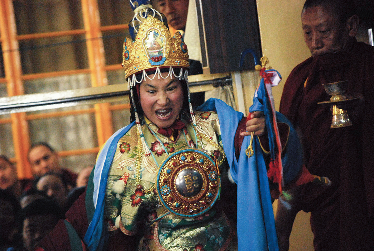 A person in gold clothing, holding a flag.