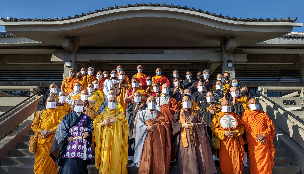 A group of people all wearing robes and masks posing together.