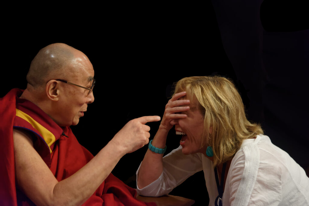 His Holiness the Dalai Lama shares a laugh with "Mission: Joy" filmmaker Peggy Callahan.