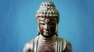 Buddha statue on blue background.