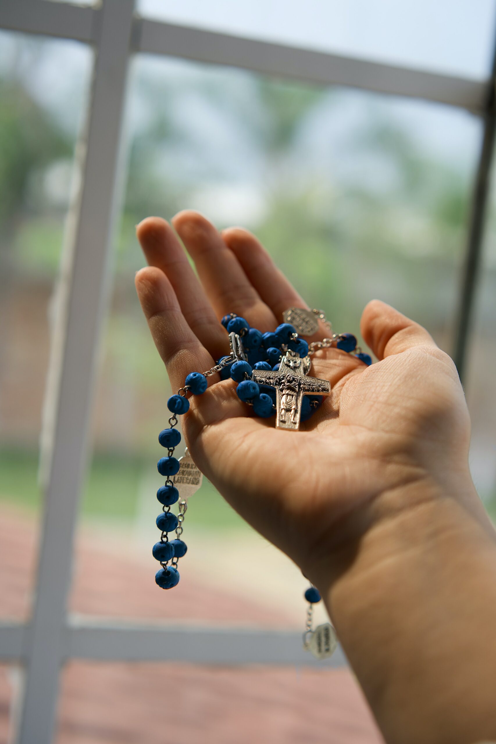 rosary held in hand.
