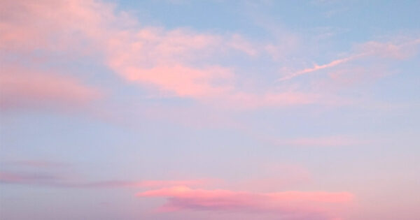 Pink clouds in blue sky