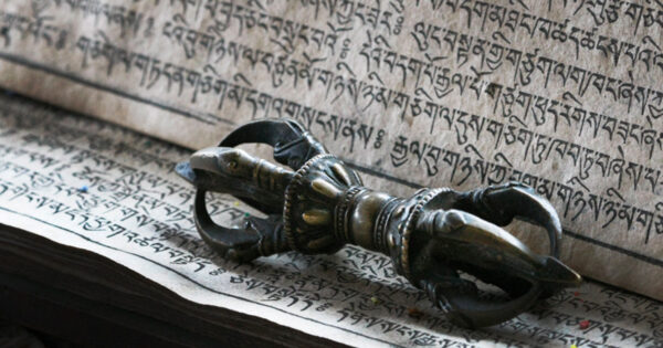 A dorje sits on a page of tibetan writing