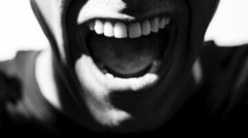Black and white illustration of person yelling