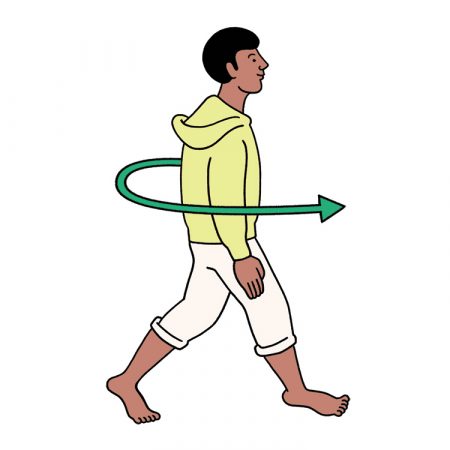 A man in a yellow sweater practices walking meditation.
